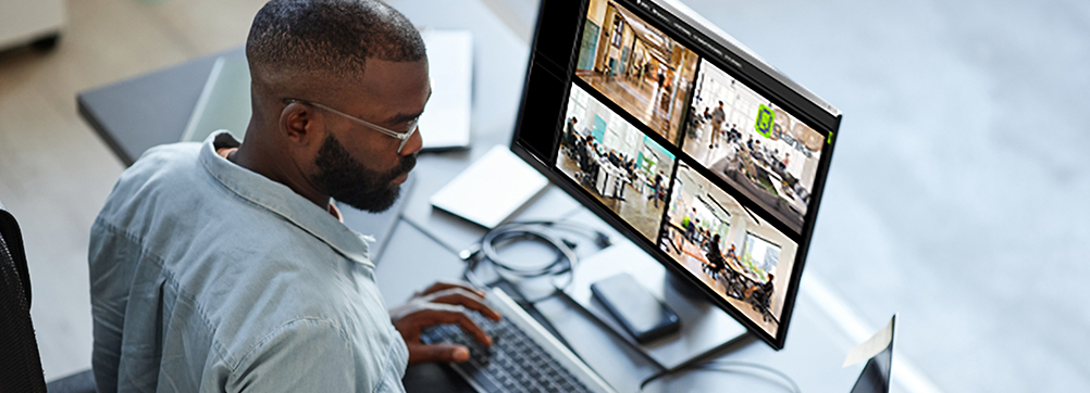 person on a computer with cctv on
