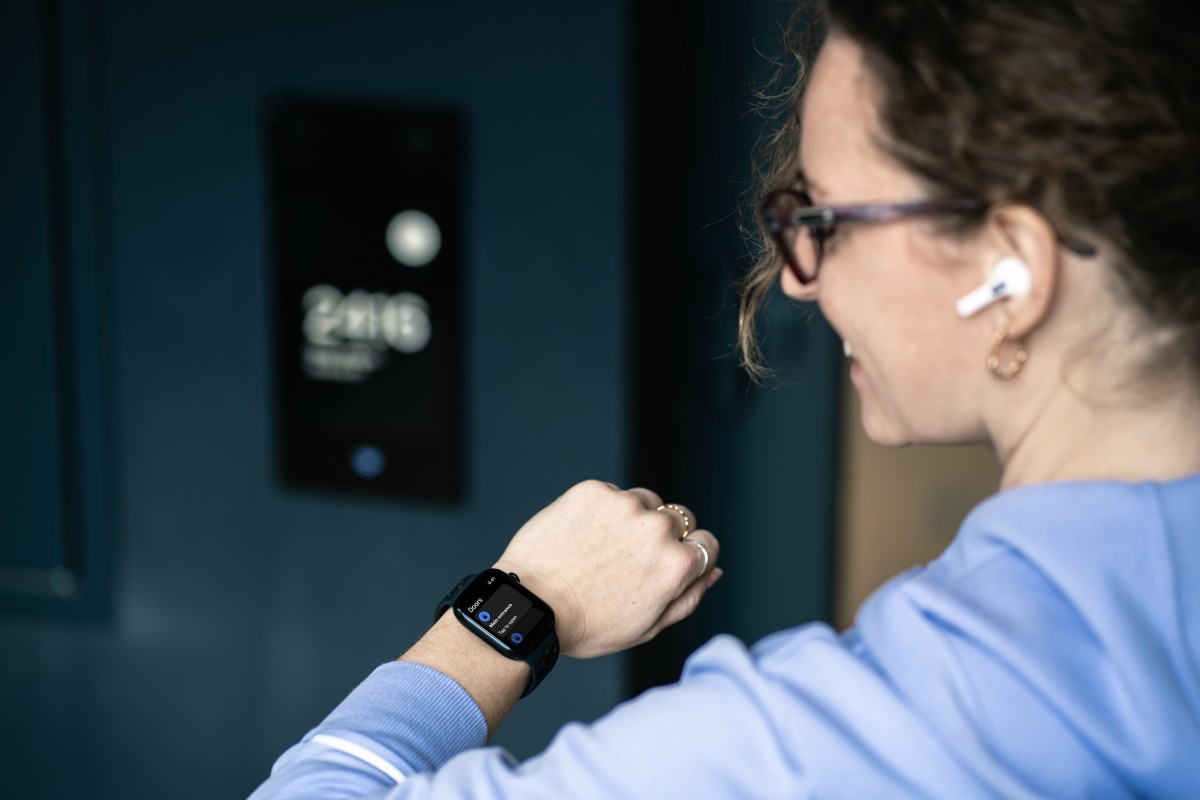 image of woman with apple watch unlocking their door