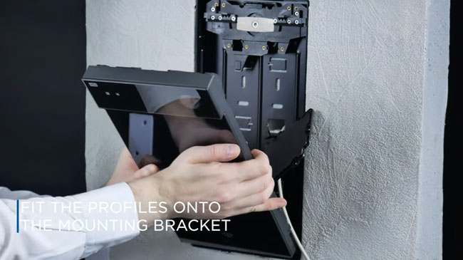 2N IP Style - fit the profiles on the device back onto the mounting bracket