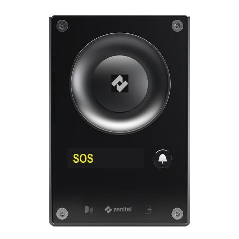 Zenitel TCIS-4 black IP intercom station featuring a large circular speaker, yellow SOS emergency label, dedicated call button with bell icon, and four corner mounting screws.