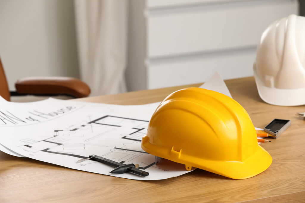 Architectural plans and hard hat for EN54 system design