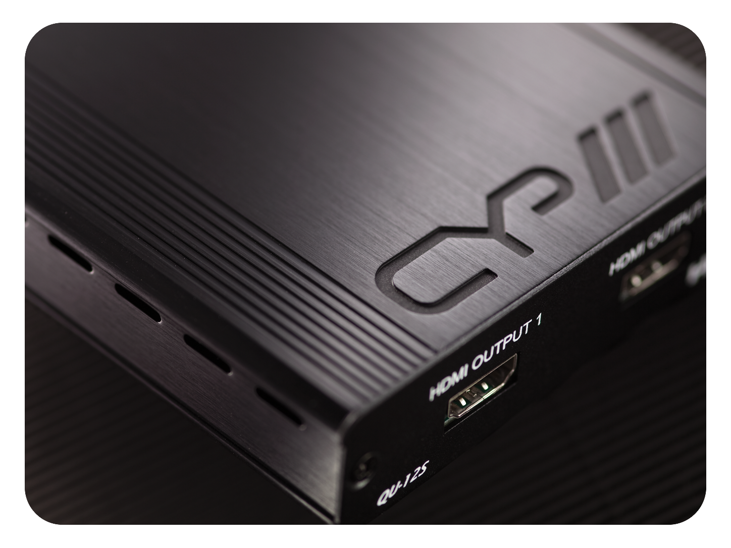 Close-up of a CYP QU-12S HDMI distribution amplifier with HDMI output port and black metal enclosure