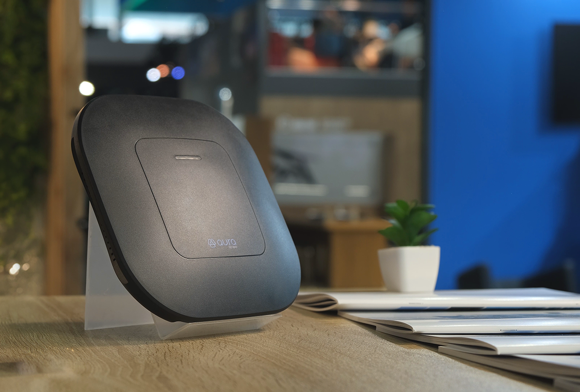 Aura smart device displayed on a tabletop stand in a modern showroom environment