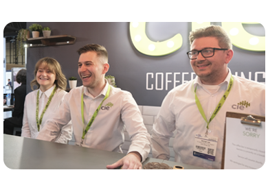 CIE Group team members at the TSE trade show stand, smiling and speaking with visitors