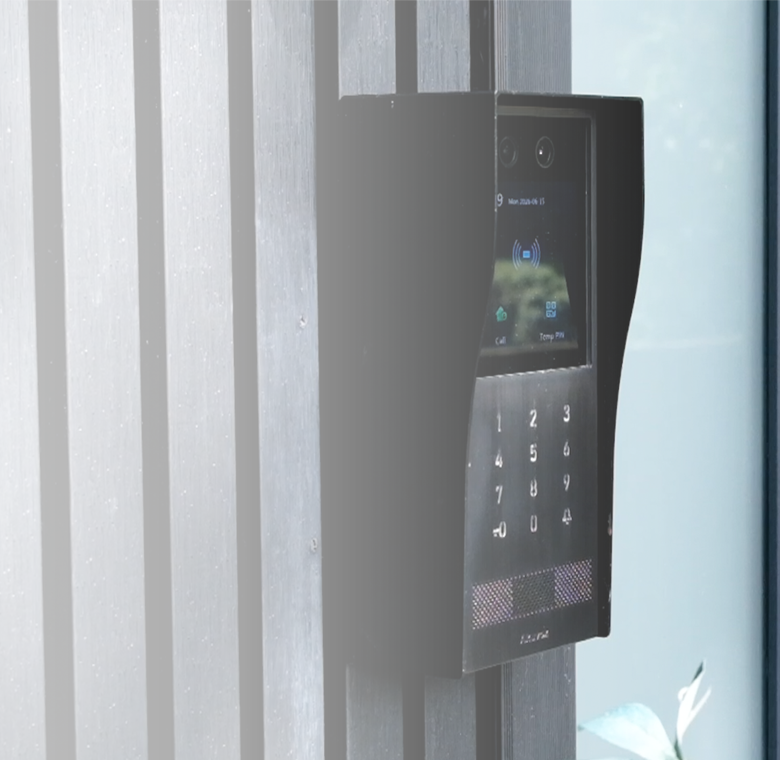 Akuvox smart video intercom mounted beside a building entrance, featuring dual cameras, touchscreen, keypad and contactless access
